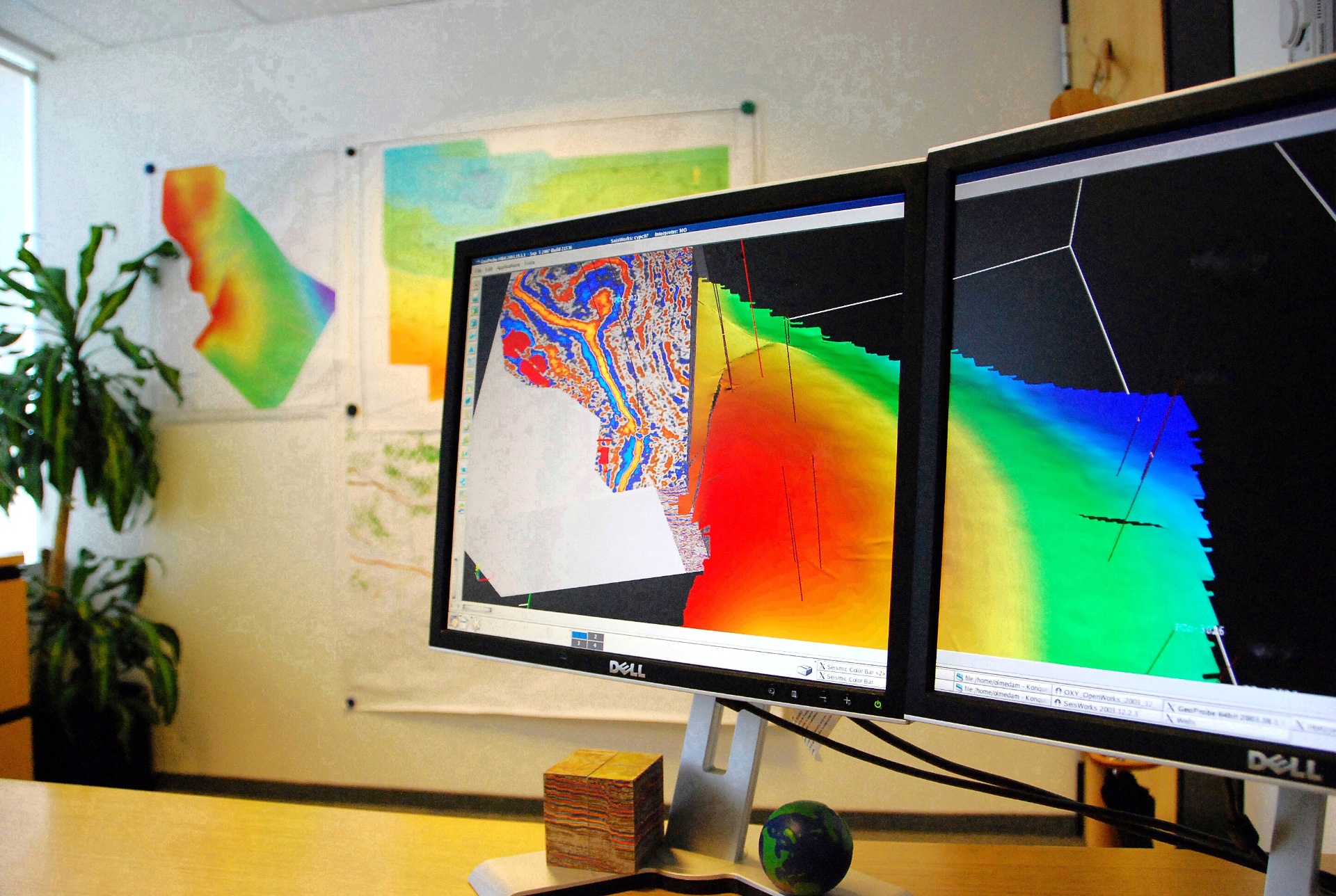 Geoscience workstation displaying seismic interpretation and 3D subsurface models